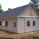 newly built tan horse barn