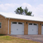 tan custom pole garage with two doors