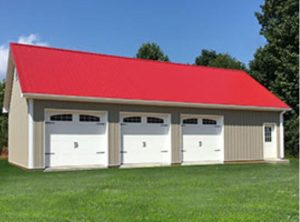 amish built garage with three white garage doors, tan siding, and red roofing