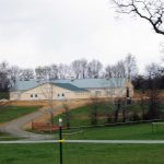 large horse barn green metal roof