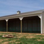 Large tan horse run in shed with 4 section openings